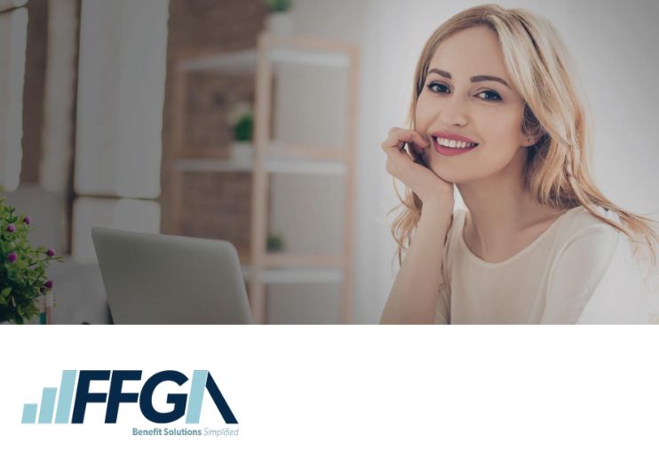 young female adult working at laptop computer and smiling, first financial group of America logo in corner